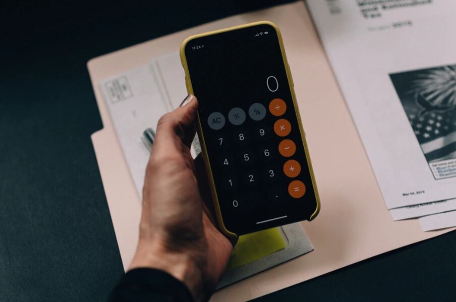 Hand holding a phone calculator.