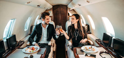 couple enjoys a meal and drinks while on private jet KHM Attorneys at Law Colorado Springs, Castle Rock