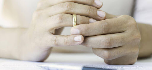woman starts taking off wedding ring preparing for divorce KHM Attorneys at Law Colorado Springs, Castle Rock