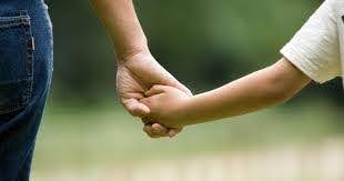 parent holds hand of young child while walking outside KHM Attorneys at Law Colorado Springs, Castle Rock