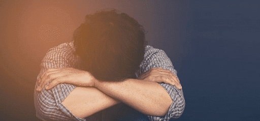 distressed person puts head in knees thinking about divorce KHM Attorneys at Law Colorado Springs, Castle Rock
