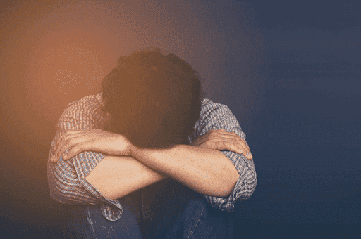 distressed person puts head in knees thinking about divorce KHM Attorneys at Law Colorado Springs, Castle Rock