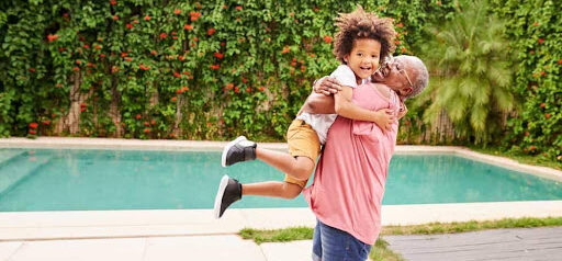grandma gives grandson a hug near swimming pool KHM Attorneys at Law Colorado Springs, Castle Rock
