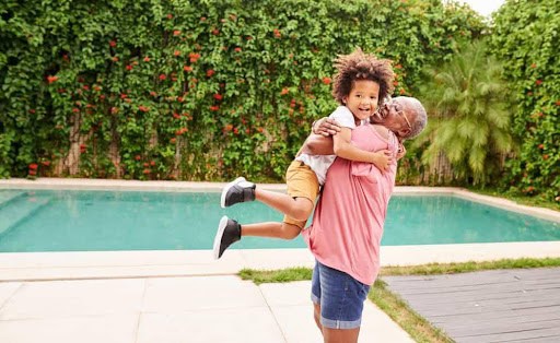 grandma gives grandson a hug near swimming pool KHM Attorneys at Law Colorado Springs, Castle Rock