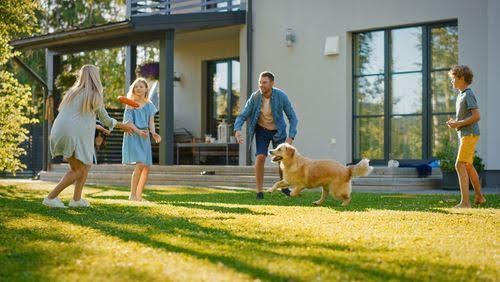 co-parenting in action with man, woman, two children and dog in backyard KHM Attorneys at Law Colorado Springs, Castle Rock