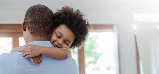 young child hugs dad around the neck KHM Attorneys at Law Colorado Springs, Castle Rock