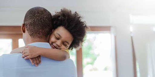 young child hugs dad around the neck KHM Attorneys at Law Colorado Springs, Castle Rock