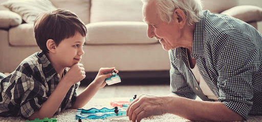 Grandpa plays on floor with grandson KHM Attorneys at Law Colorado Springs, Castle Rock
