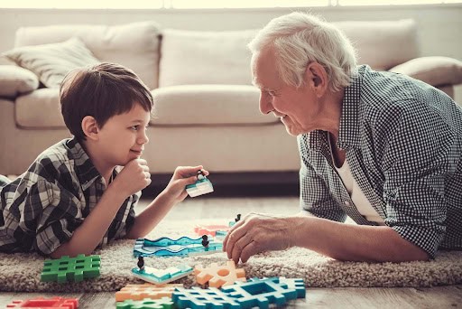 Grandpa plays on floor with grandson KHM Attorneys at Law Colorado Springs, Castle Rock