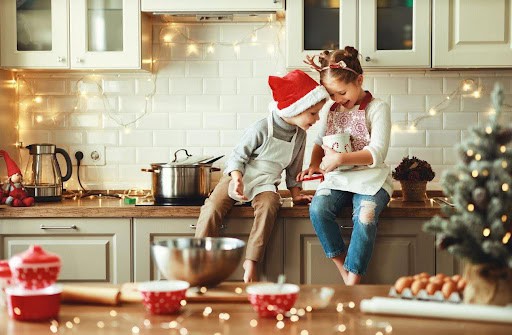 two children enjoy the holidays in the kitchen making treats KHM Attorneys at Law Colorado Springs, Castle Rock