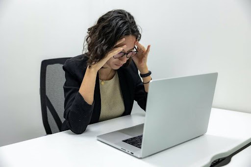 woman is unhappy looking at laptop computer KHM Attorneys at Law Colorado Springs, Castle Rock