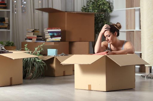 woman is stressed to pack because she did not get the house in the divorce KHM Attorneys at Law Colorado Springs, Castle Rock