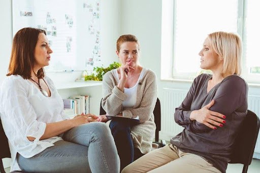 two women discuss the troubles with their relationship with a mediator listening KHM Attorneys at Law Colorado Springs, Castle Rock