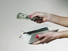 woman hands over money out of her wallet to pay for lawyer KHM Attorneys at Law Colorado Springs, Castle Rock