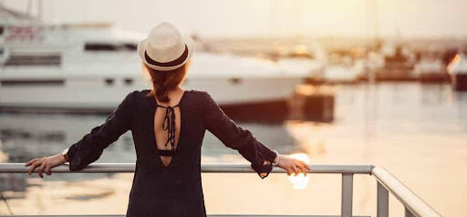 woman wearing hat looks toward harbor and a boat wondering about her high asset divorce KHM Attorneys at Law Colorado Springs, Castle Rock