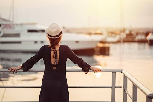 woman wearing hat looks toward harbor and a boat wondering about her high asset divorce KHM Attorneys at Law Colorado Springs, Castle Rock