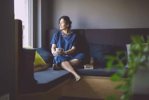 woman sits on couch thinking about her high net worth pending divorce KHM Attorneys at Law Colorado Springs, Castle Rock