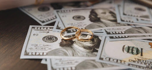 several 100 dollar bills with two wedding rings sitting on top showing spousal maintenance KHM Attorneys at Law Colorado Springs, Castle Rock
