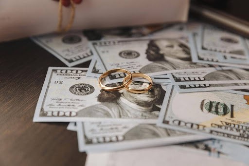 several 100 dollar bills with two wedding rings sitting on top showing spousal maintenance KHM Attorneys at Law Colorado Springs, Castle Rock