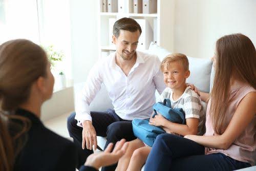 young boy sits between man and woman while speaking to a therapist about co-parenting KHM Attorneys at Law Colorado Springs, Castle Rock