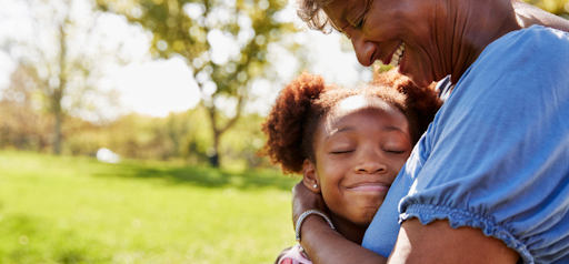 young girl hugs grandma at a park KHM Attorneys at Law Colorado Springs, Castle Rock