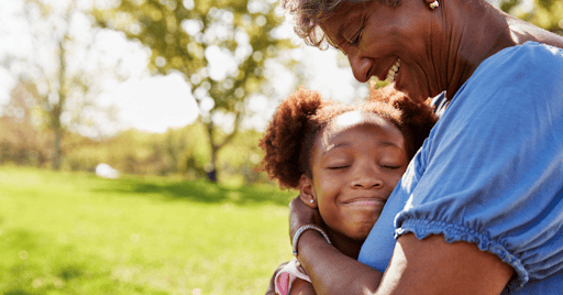 young girl hugs grandma at a park KHM Attorneys at Law Colorado Springs, Castle Rock