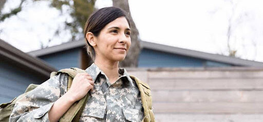 woman in military wears backpack as she goes to work KHM Attorneys at Law Colorado Springs, Castle Rock