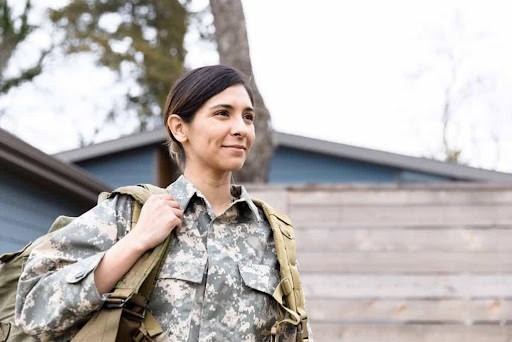 woman in military wears backpack as she goes to work KHM Attorneys at Law Colorado Springs, Castle Rock