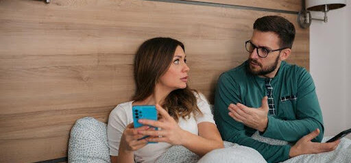 man and woman sitting in bedroom while in a disagreement KHM Attorneys at Law Colorado Springs, Castle Rock