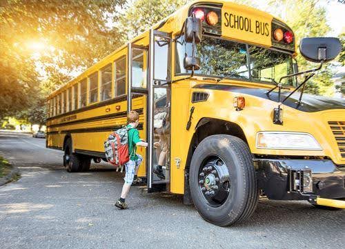 young boy in green shirt gets on school bus KHM Attorneys at Law Colorado Springs, Castle Rock