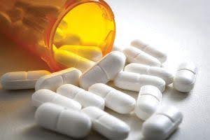 pill bottle knocked over showing possible substance abuse with white pills on table KHM Attorneys at Law Colorado Springs, Castle Rock