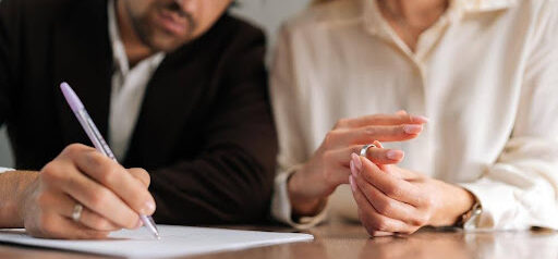 man signs protection order as woman removes wedding ring KHM Attorneys at Law Colorado Springs, Castle Rock
