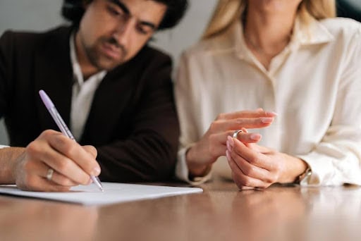 man signs protection order as woman removes wedding ring KHM Attorneys at Law Colorado Springs, Castle Rock