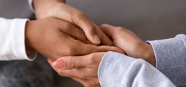 woman holds hands of young child showing support and love KHM Attorneys at Law Colorado Springs, Castle Rock