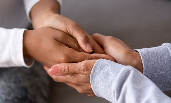 woman holds hands of young child showing support and love KHM Attorneys at Law Colorado Springs, Castle Rock