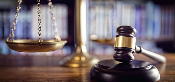 legal scale with gavel in foreground KHM Attorneys at Law Colorado Springs, Castle Rock