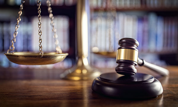 legal scale with gavel in foreground KHM Attorneys at Law Colorado Springs, Castle Rock