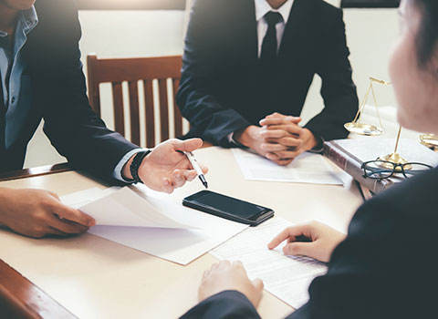 image of three attorneys discussing legal documents KHM Attorneys at Law Colorado Springs, Castle Rock
