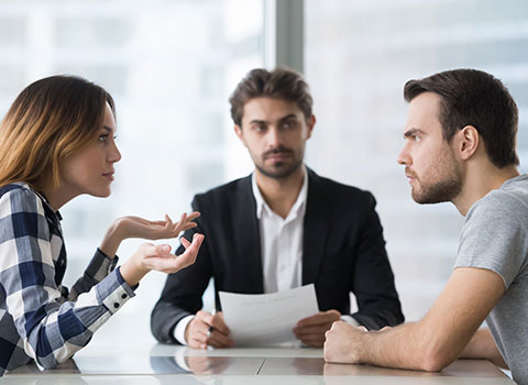man and woman at arbitration with a mediator sitting between them KHM Attorneys at Law Colorado Springs, Castle Rock